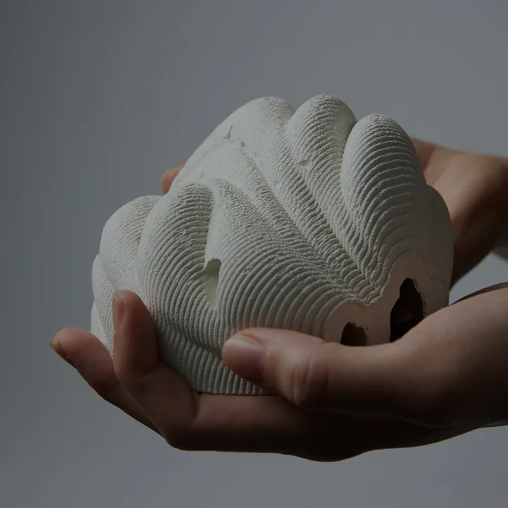 Miniature reef replica held in two hands