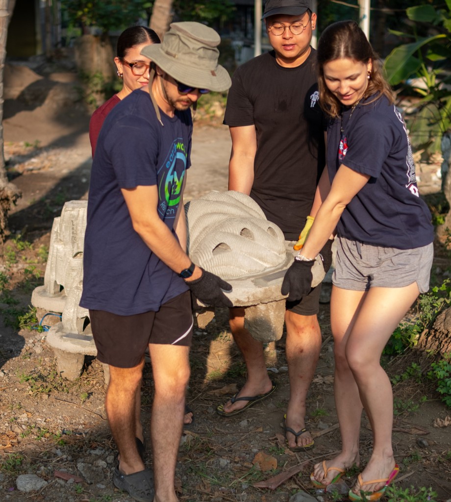 Team carrying a pet community reef structure