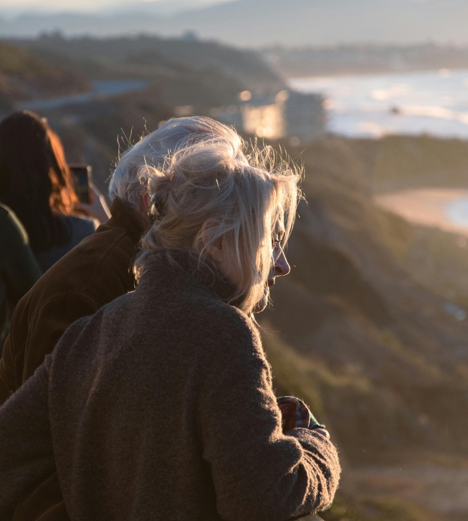 Person at coastal viewpoint during sunset